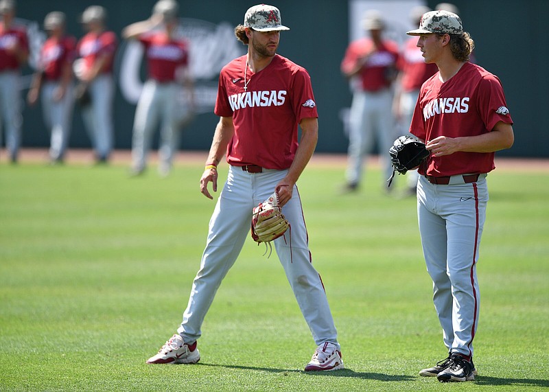 Arkansas pitchers Hunter Hollan (center) and Hagen Smith (right) watch Thursday, June 1, 2023, during practice at Baum-Walker Stadium in Fayetteville. Arkansas, Texas Christian, Arizona and Santa Clara practiced at the stadium ahead of today’s opening-round games in the NCAA Fayetteville Regional. Visit nwaonline.com/photo for today's photo gallery. .(NWA Democrat-Gazette/Andy Shupe)