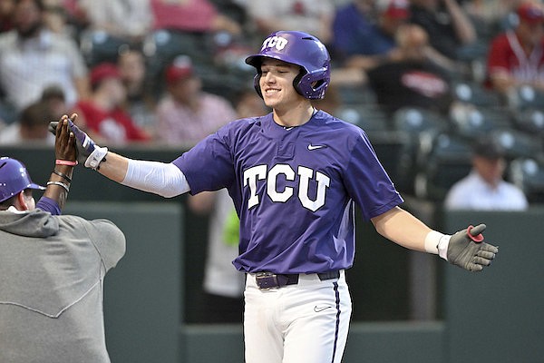 TCU batter Brayden Taylor is greeted by teammates after hitting home run against Arizona during an NCAA baseball game on Friday, June 2, 2023, in Fayetteville. (AP Photo/Michael Woods)