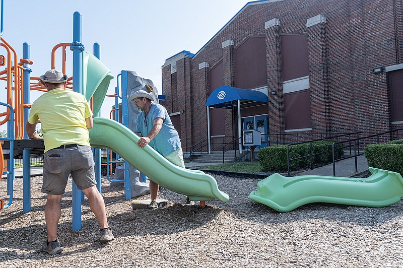 Jeff Croft, (from right) and Brandon Croft work to replace a slide at the Rogers Boys and Girls club Friday June 2, 2023, in Rogers. The club had is grand reopening Friday after a having a $300,000 dollar renevation. (NWA Democrat-Gazette/Spencer Tirey)