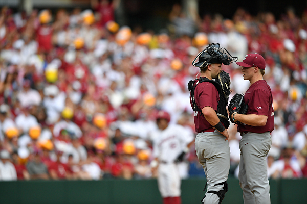 Santa Clara pitcher Cole Kitchen meets with catcher Ben Steck on Friday, June 2, 2023, during the Razorbacks’ 13-6 win over Santa Clara in the first round of the NCAA Fayetteville Regional at Baum-Walker Stadium in Fayetteville.