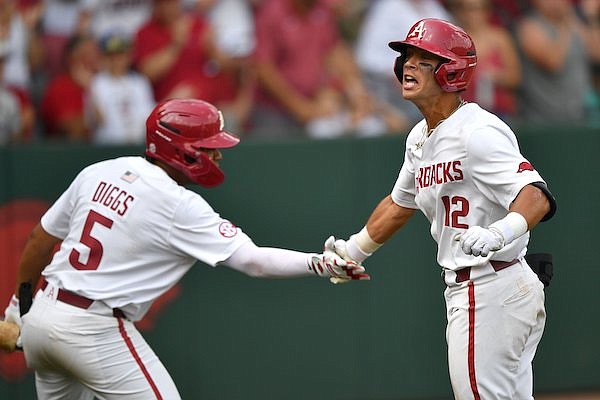 Arkansas center fielder Tavian Josenberger (12) celebrates Friday, June 2, 2023, with designated hitter Kendall Diggs after hitting a two-run home run during the sixth inning of the Razorbacks’ 13-6 win over Santa Clara in the first round of the NCAA Fayetteville Regional at Baum-Walker Stadium in Fayetteville.