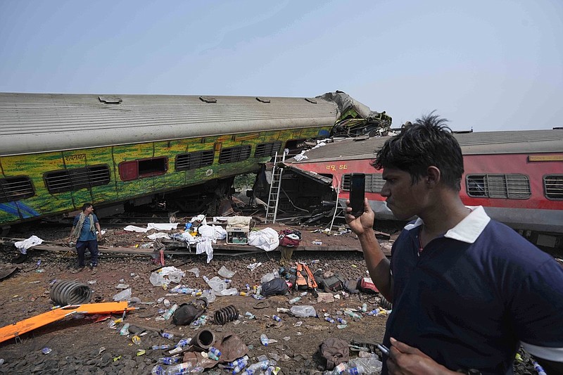 People inspect the site of passenger trains that derailed in Balasore district, in the eastern Indian state of Orissa, Saturday, June 3, 2023. (AP/Rafiq Maqbool)