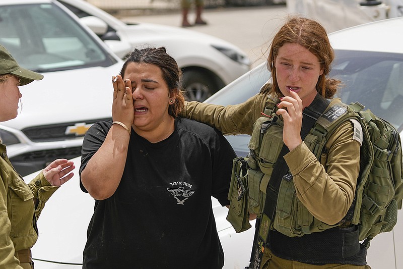 An Israeli soldier cries outside a military base following a deadly shootout in southern Israel along the Egyptian border, Saturday, June 3, 2023. (AP/Tsafrir Abayov)