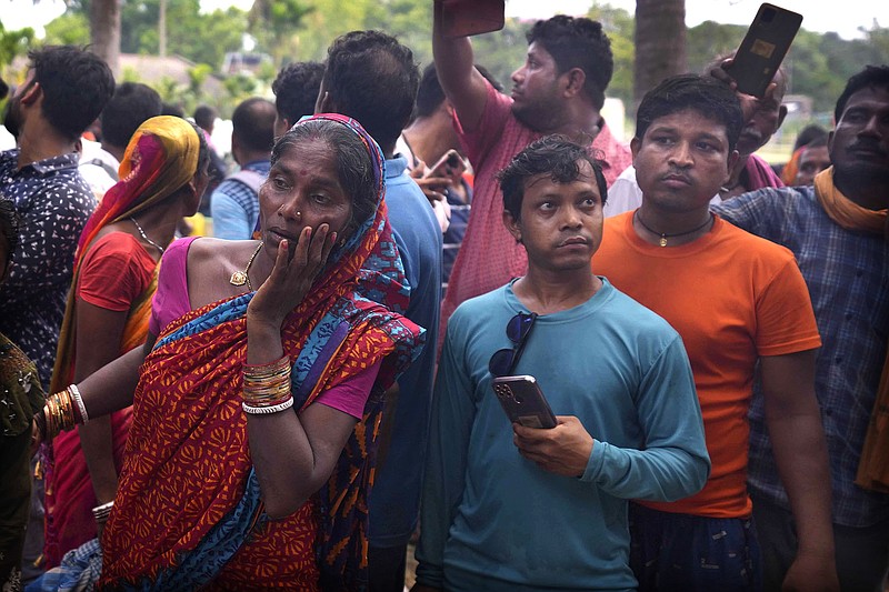 People react as the body of victim is carried out at the site of passenger trains that derailed in Balasore district, in the eastern Indian state of Orissa, Saturday, June 3, 2023. Rescuers in India have found no more survivors in the overturned and mangled wreckage of two passenger trains that derailed, killing more than 280 people and injuring hundreds in one of the country's deadliest rail crashes in decades. (AP Photo/Rafiq Maqbool)
