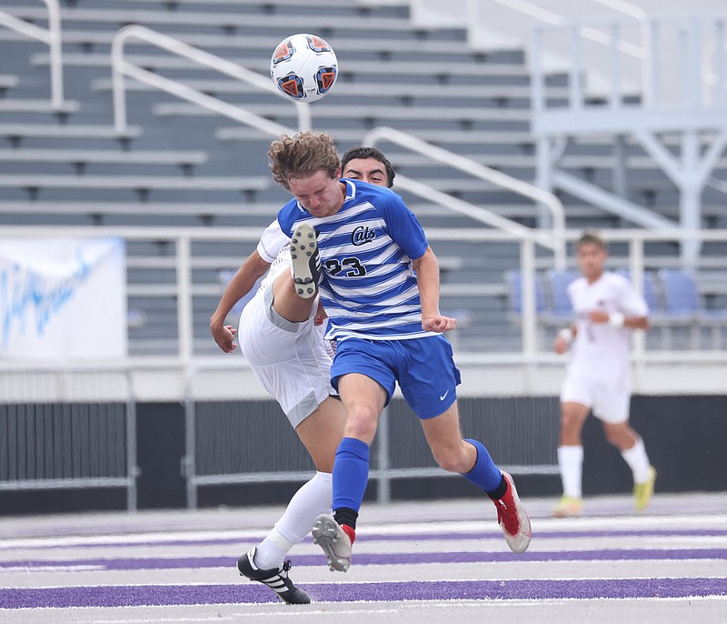 Conway's Will Childers (23) heads the ball while defended by Springdale's Saul Acosta during the Arkansas 6A state boys soccer championship game at Estes Stadium on the UCA campus in Conway on Friday, May 19, 2023. See more photos at arkansasonline.com/520boyssoccer6A/ (Arkansas Democrat-Gazette/Colin Murphey)