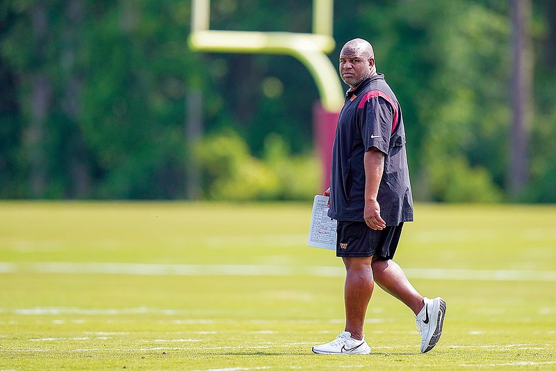 Commanders offensive coordinator Eric Bieniemy walks on the field during practice at the team’s training facility last month in Ashburn, Va. (Associated Press)