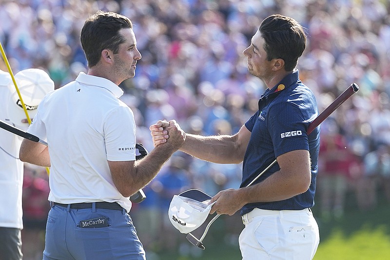 Viktor Hovland (right) shakes the hand of Denny McCarthy after Hovland defeated McCarthy on the first playoff hole Sunday to win the Memorial  in Dublin, Ohio. (Associated Press)