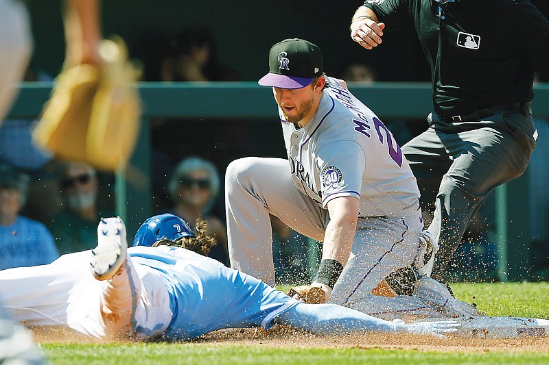 Bobby Witt Jr. of the Royals is tagged out by Rockies third baseman Ryan McMahon after getting caught off the base by catcher Elias Diaz during the third inning of Saturday’s game at Kauffman Stadium in Kansas City. (Associated Press)