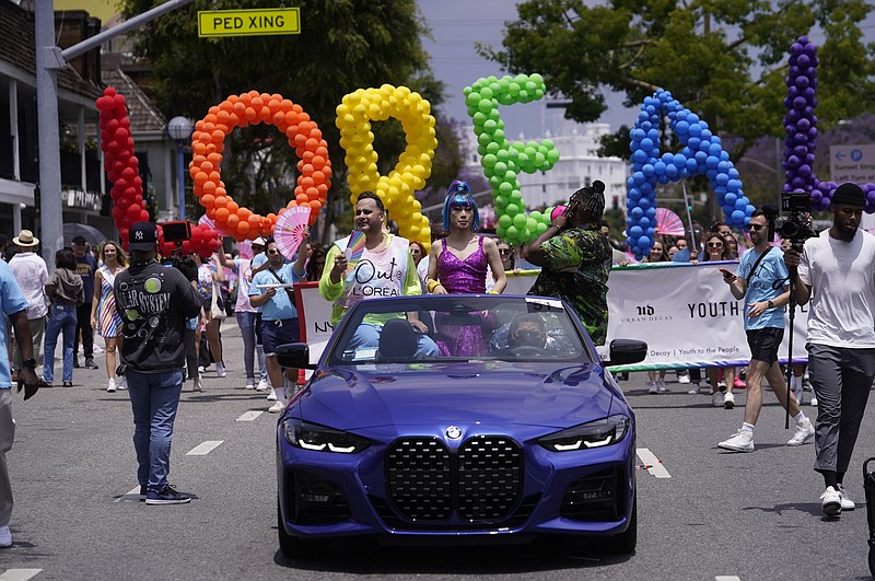 The cosmetics brand L'Oréal is spelled with colorful balloons at the WeHo Pride Parade in West Hollywood, Calif., on Sunday, June 4, 2023. Longtime Pride sponsors have come under attack by conservatives for their LGBTQ-friendly marketing. (AP Photo/Damian Dovarganes)