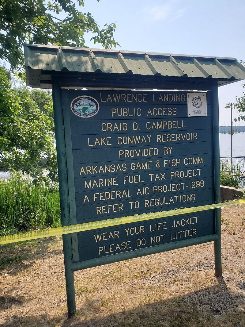 The sign for the Lawrence Landing Public Access boat ramp is shown with crime scene tape around it on Monday, June 5, 2023. (Photo Courtesy of Faulkner County sheriff's office spokesman Sherry Skaggs)