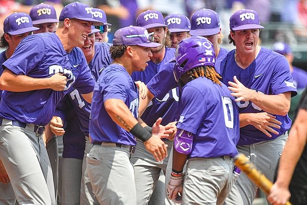 TCU second baseman Tre Richardson (0) celebrates with teammates after hitting a grand slam, Sunday, June 4, 2023, during the first inning of the Arkansas Razorbacks’ game against TCU in the second round of the NCAA Fayetteville Regional at Baum-Walker Stadium in Fayetteville.