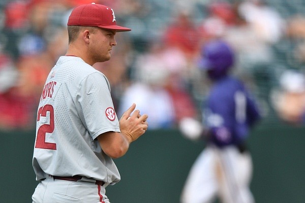 Arkansas reliever Zack Morris watches Monday, June 5, 2023, as Texas Christian right fielder Austin Davis rounds third and heads to the plate after hitting a 2-run home run during the sixth inning of the Razorbacks’ 12-4 loss in the championship series of the NCAA Fayetteville Regional at Baum-Walker Stadium in Fayetteville.