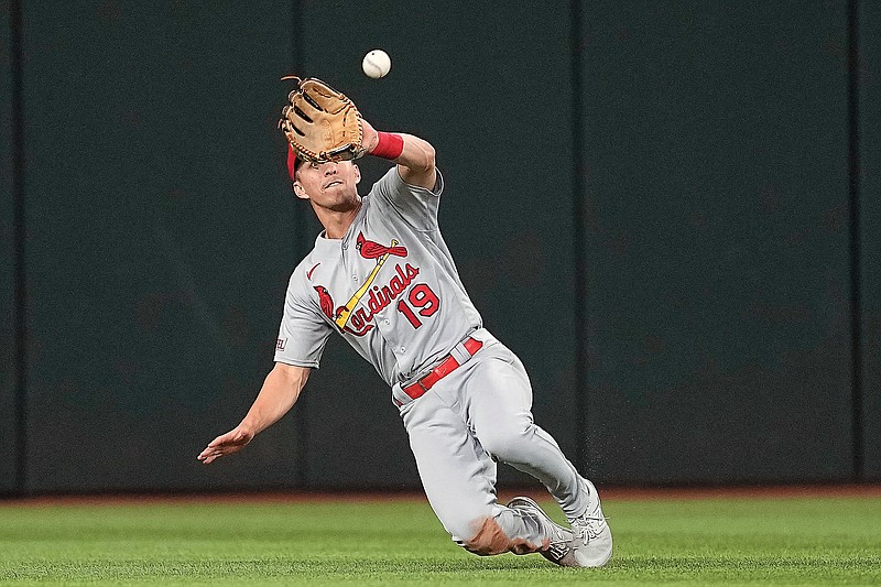 Cardinals center fielder Tommy Edman makes a sliding catch of a fly ball by Marcus Semien of the Rangers during the sixth inning of Tuesday night’s game in Arlington, Texas. (Associated Press)