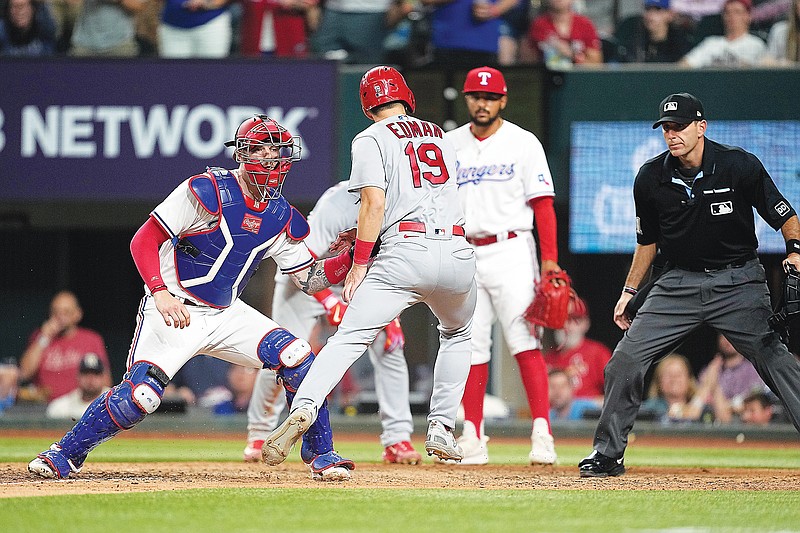 Rangers catcher Jonah Heim tags out Tommy Edman of the Cardinals who was trying to score on a Nolan Arenado double in the eighth inning of Monday night’s game in Arlington, Texas. (Associated Press)