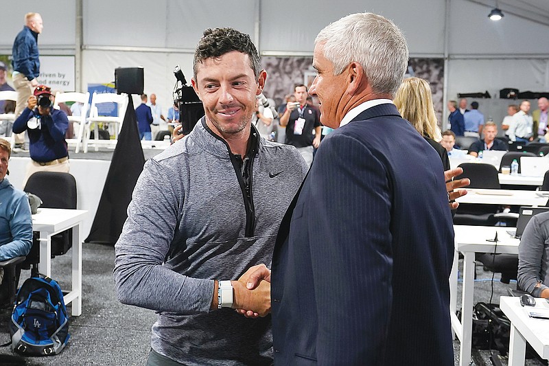 In this Aug. 24, 2022, file photo, Rory McIlroy shakes hands with PGA Tour commissioner Jay Monahan after a press conference prior to the start of the Tour Championship in Atlanta. (Associated Press)