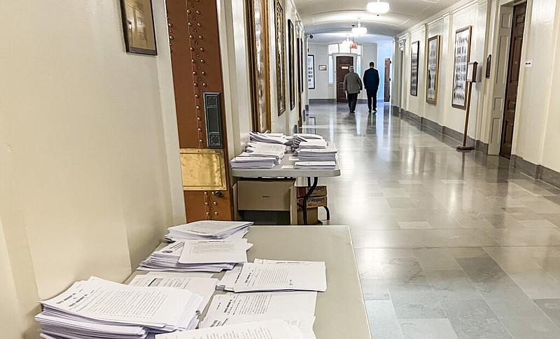 State Rep. Brad Pollitt, R-Sedalia, Mo., and House Speaker Dean Plocher, R-Des Peres, Mo., walk into the Missouri Senate president pro tem's office in the midst of closed door negotiations May 4, 2023. Stacks of amendments pile up outside the Senate copy room during the last days of the legislative session. (Annelise Hanshaw/Missouri Independent photo)