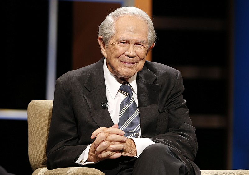 FILE - Rev. Pat Robertson poses a question to a Republican presidential candidate during a forum at Regent University in Virginia Beach, Va., Oct. 23, 2015. Robertson, a religious broadcaster who turned a tiny Virginia station into the global Christian Broadcasting Network, tried a run for president and helped make religion central to Republican Party politics in America through his Christian Coalition, has died. He was 93. Robertson's death Thursday, June 8, 2023 was announced by his broadcasting network. (AP Photo/Steve Helber, File)