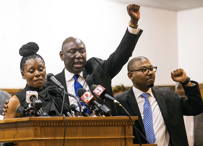 Attorney Ben Crump, center, shouts "Justice for A.J.!" while flanked by Pamela Dias, left, mother of Ajike "AJ" Owens and attorney Anthony Thomas, right, during a press conference Wednesday afternoon, June 7, 2023 at the New St. John Missionary Baptist Church in Ocala, Fla. Susan Louise Lorincz, 58, who is accused of fatally shooting Owens last week in the violent culmination of what the sheriff described as a 2 and a half year feud was arrested Tuesday, June 6, the Marion County Sheriff’s Office said. (Doug Engle/Ocala Star-Banner via AP)