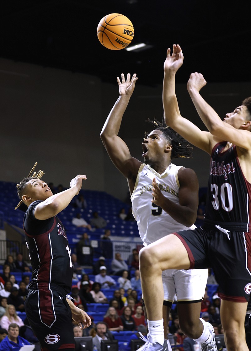 Jonesboro's Phillip Tillman (5) lays in a shot over Springdale's Isaiah Sealy (30) during the fourth quarter of Jonesboro's 48-43 win in the Class 6A state championship game on Friday, March 10, 2023, at Bank OZK Arena in Hot Springs. Tillman is one of three players to sign with South Arkansas College this offseason so far. (Arkansas Democrat-Gazette/Thomas Metthe)