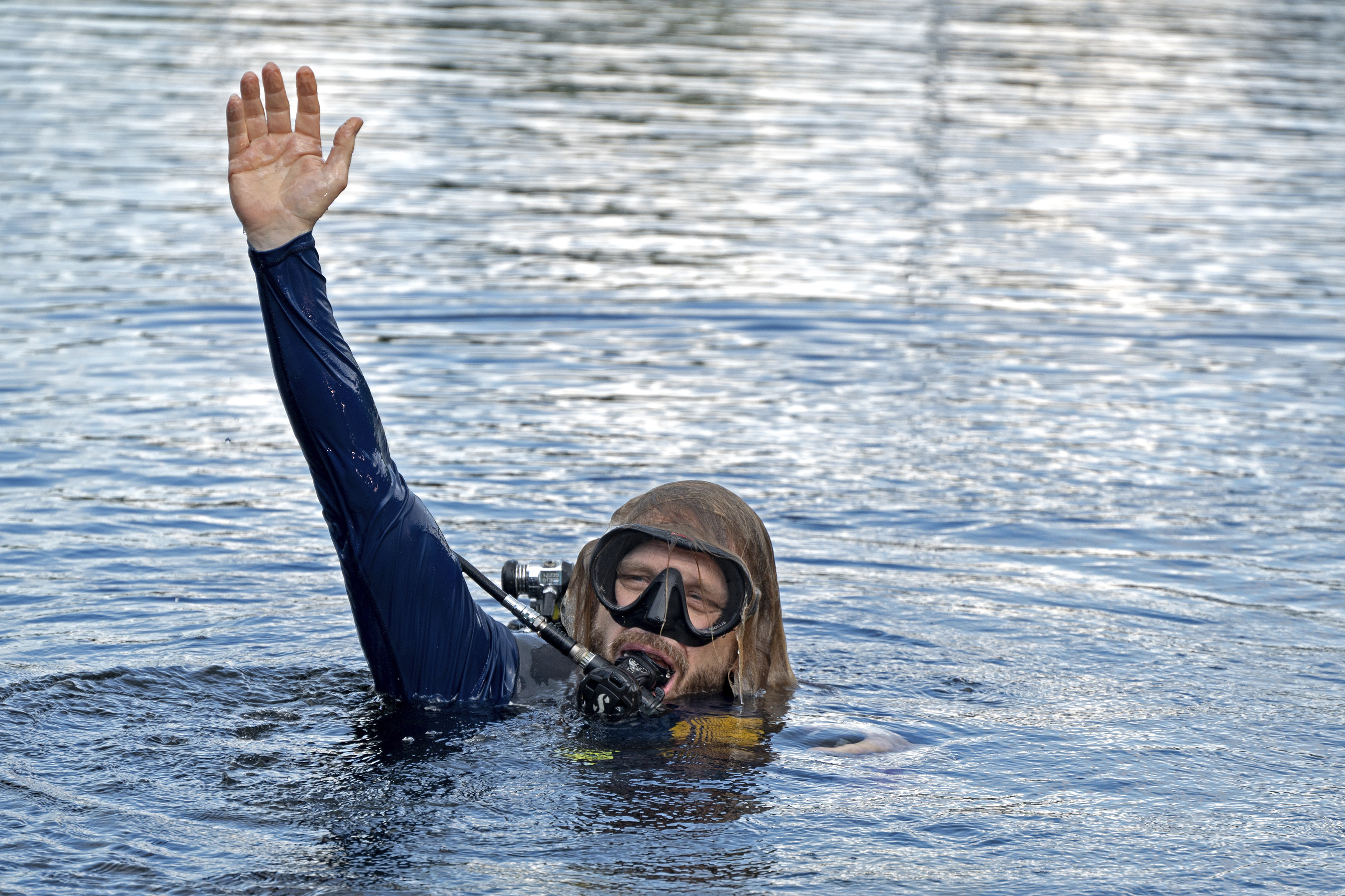 In this photo provided by the Florida Keys News Bureau, diving explorer and medical researcher Dr. Joseph Dituri surfaces Friday, June 9, 2023, after living for 100 days in the Jules' Undersea Lodge marine habitat at the bottom of a lagoon in Key Largo, Fla. Dituri broke the previous 73-day record for underwater human habitation at ambient pressure, undertook medical and marine science research and interacted online with more than 5,500 students during his Project Neptune 100 mission organized by the Marine Resources Development Foundation. (Andy Newman/Florida Keys News Bureau via AP)