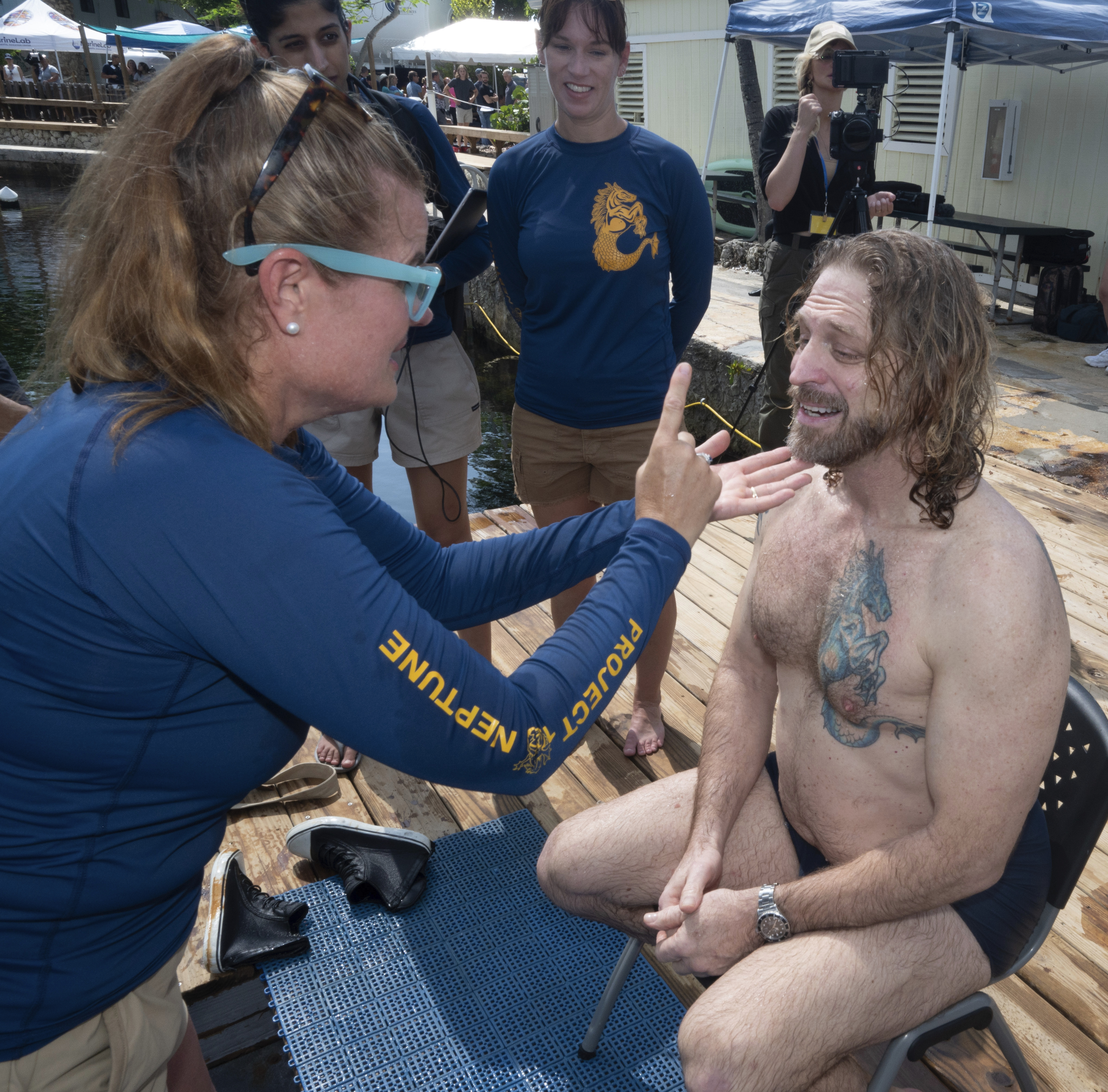 In this photo provided by the Florida Keys News Bureau, diving explorer and medical researcher Dr. Joseph Dituri, right, is examined by Dr. Sarah Spelsberg, left, Friday, June 9, 2023, after living for 100 days in the Jules' Undersea Lodge marine habitat at the bottom of a lagoon in Key Largo, Fla. Dituri broke the previous 73-day record for underwater human habitation at ambient pressure, undertook medical and marine science research and interacted online with more than 5,500 students during his Project Neptune 100 mission organized by the Marine Resources Development Foundation. (Andy Newman/Florida Keys News Bureau via AP)