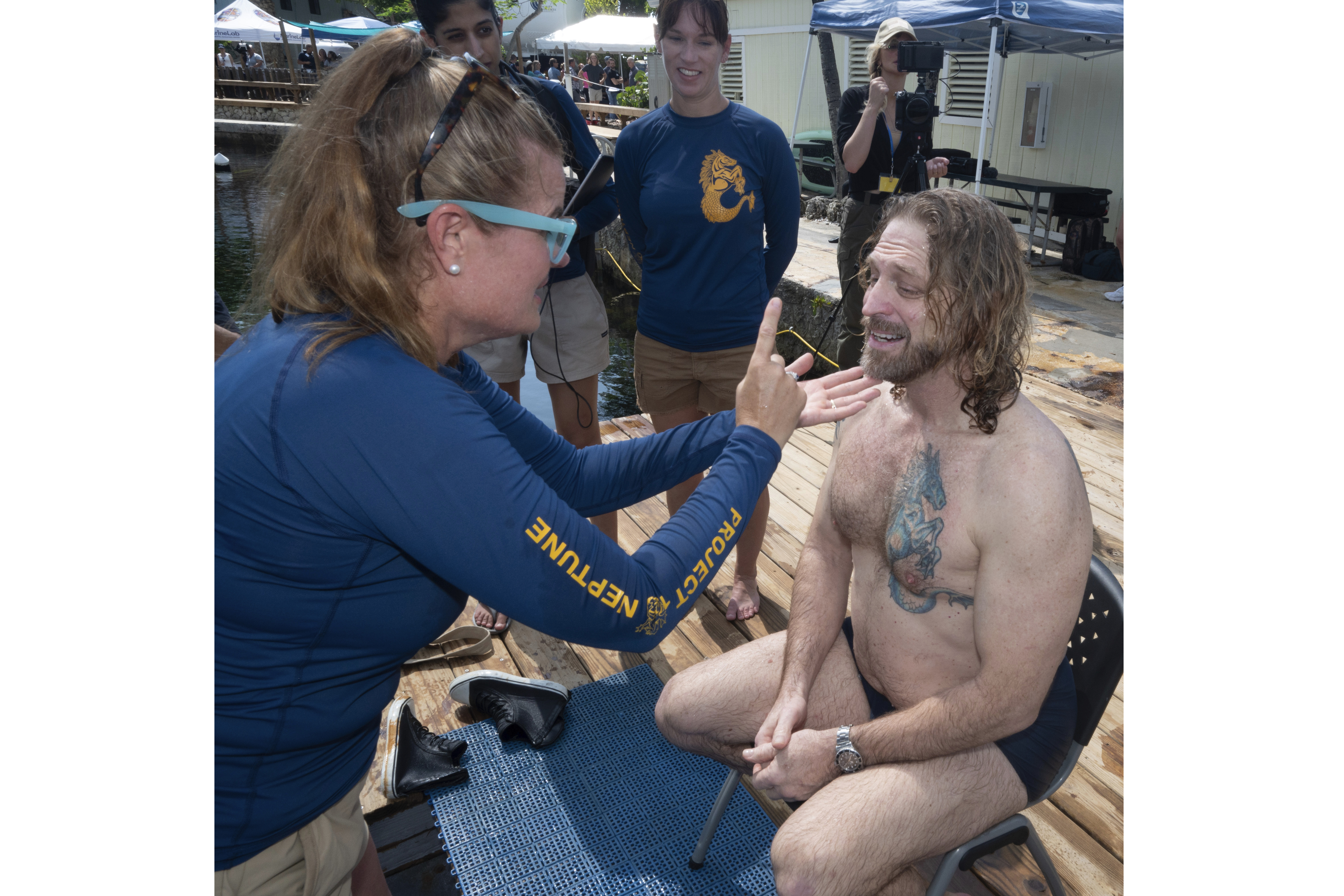 In this photo provided by the Florida Keys News Bureau, diving explorer and medical researcher Dr. Joseph Dituri, right, is examined by Dr. Sarah Spelsberg, left, Friday, June 9, 2023, after living for 100 days in the Jules' Undersea Lodge marine habitat at the bottom of a lagoon in Key Largo, Fla. Dituri broke the previous 73-day record for underwater human habitation at ambient pressure, undertook medical and marine science research and interacted online with more than 5,500 students during his Project Neptune 100 mission organized by the Marine Resources Development Foundation. (Andy Newman/Florida Keys News Bureau via AP)