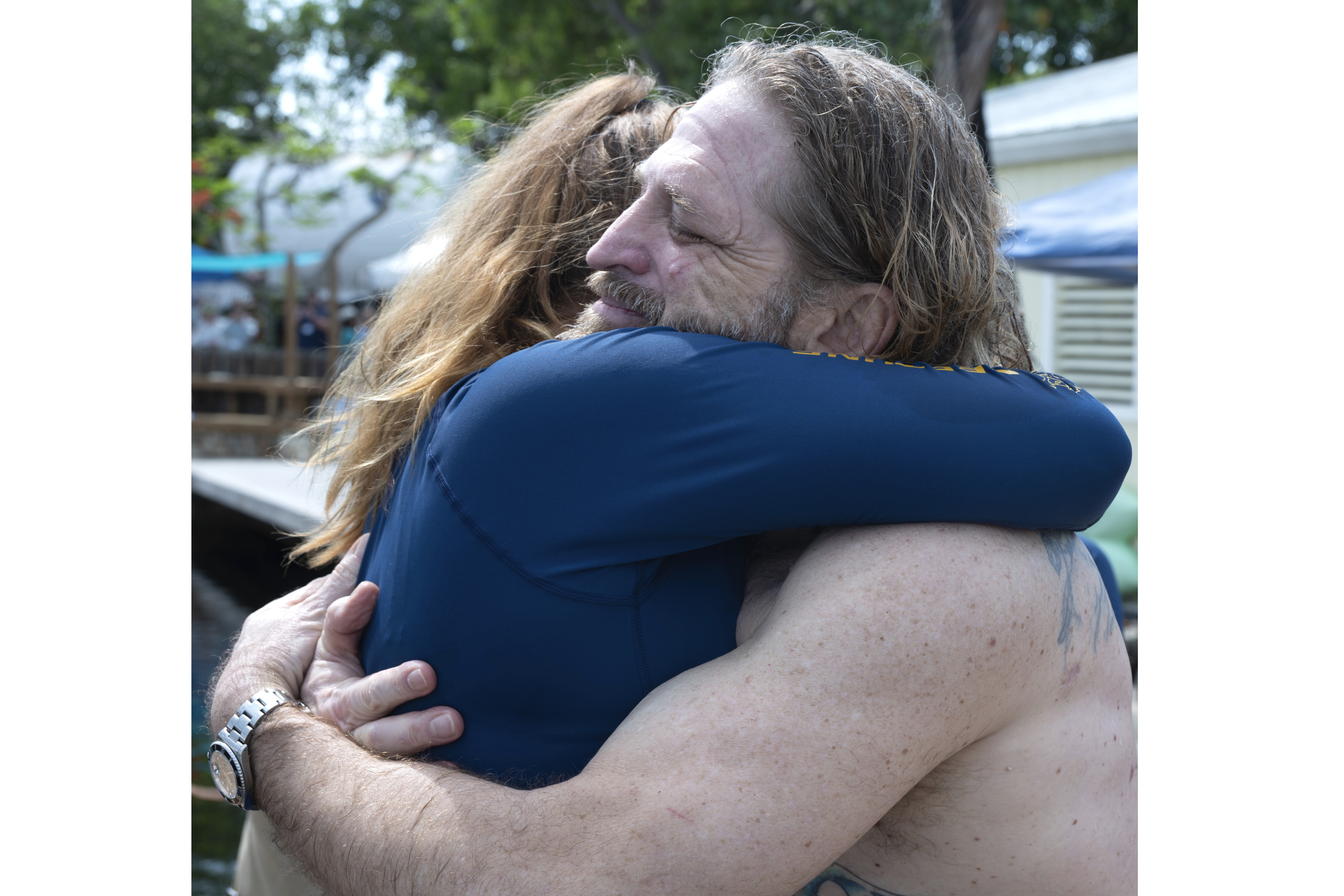 In this photo provided by the Florida Keys News Bureau, diving explorer and medical researcher Dr. Joseph Dituri hugs his lead physician, Dr. Sarah Spelsberg, Friday, June 9, 2023, after living for 100 days in the Jules' Undersea Lodge marine habitat at the bottom of a lagoon in Key Largo, Fla. Dituri broke the previous 73-day record for underwater human habitation at ambient pressure, undertook medical and marine science research and interacted online with more than 5,500 students during his Project Neptune 100 mission organized by the Marine Resources Development Foundation. (Andy Newman/Florida Keys News Bureau via AP)
