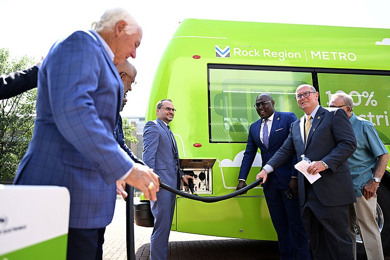 (From left) North Little Rock Mayor Terry Hartwick, left, Rock Region METRO CEO Justin Avery, Little Rock Mayor Frank Scott, Jr, and Pulaski County Judge Barry Hyde participate in a plug-in ceremony to celebrate the city’s new battery electric bus on Tuesday, June 13, 2023. The electric buses are set to replace the city’s old diesel fleet...(Arkansas Democrat-Gazette/Stephen Swofford)