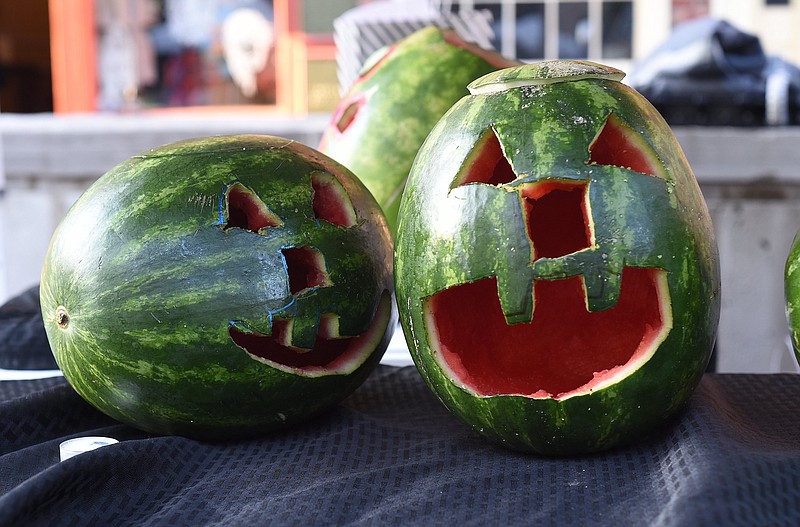 Staff file photo by Matt Hamilton / Carved watermelons sit on a table during Summerween in Patten Square on July 16, 2022. The summer celebration of Halloween returns June 24.
