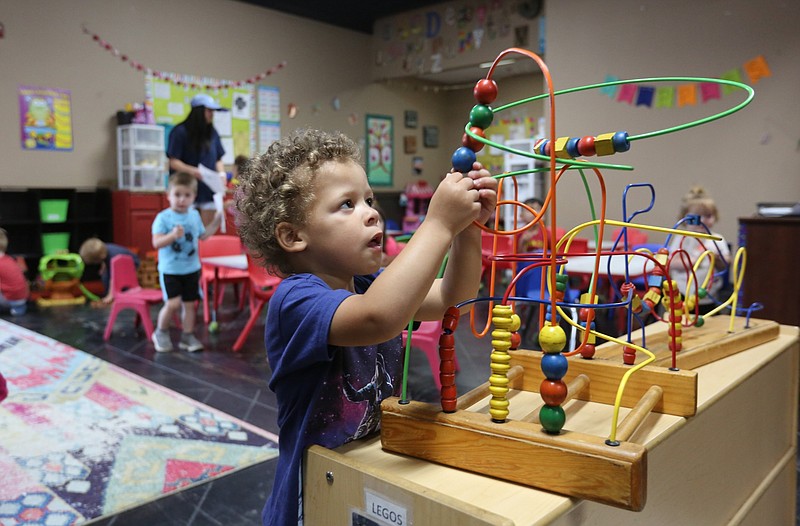 Grayson Smith, then age 2, works his way through a puzzle at Butterflies & Frogs Childcare and Preschool in Fayetteville in this May 5, 2020 file photo. The Annie E. Casey Foundation, which in June 2023 ranked Arkansas as No. 43 nationally in overall child well-being, made access to child care the foreword of the 2023 report, highlighting data that isn’t directly factored into a state’s child well-being score. (NWA Democrat-Gazette/David Gottschalk)