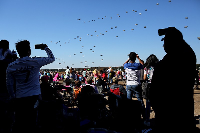 A crowd takes pictures and videos on their phones as 200 paratroopers from the 82nd Airborne Division are dropped from a line of C-130J aircraft during the Thunder Over the Rock air show on Sunday, Oct. 28, 2018, at Little Rock Air Force Base. (Arkansas Democrat-Gazette/Thomas Metthe)