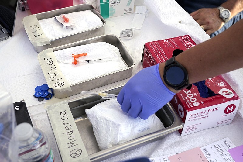 Syringes with vaccines are prepared at the L.A. Care and Blue Shield of California Promise Health Plans’ Community Resource Center in October 2022 in Lynwood, Calif.
(AP/Mark J. Terrill)