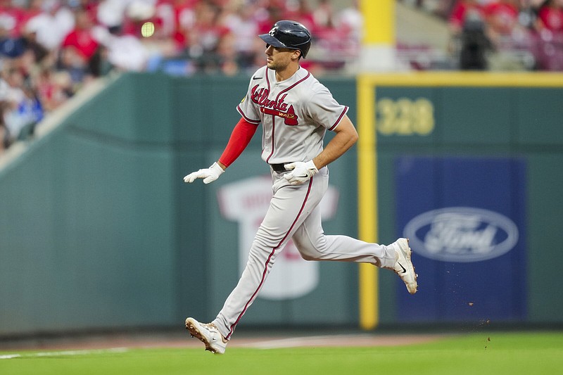 Atlanta Braves' Matt Olson gestures to the dugout as he runs the bases after hitting a two-run home run during a baseball game against the Cincinnati Reds in Cincinnati, Friday, June 23, 2023. (AP Photo/Aaron Doster)