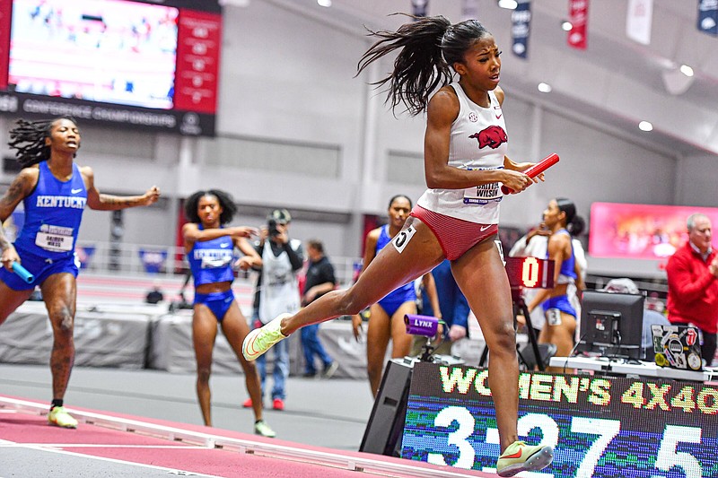 Arkansas sprinter Britton Wilson crosses the finish line in the team’s first-place performance in the 4x400-meter relay final, Saturday, Feb. 25, 2023, during the Razorbacks’ championship sweep at the Southeastern Conference 2023 Indoor Track and Field Championships at the Randal Tyson Track Center in Fayetteville. Visit nwaonline.com/photo for today's photo gallery..(NWA Democrat-Gazette/Hank Layton)