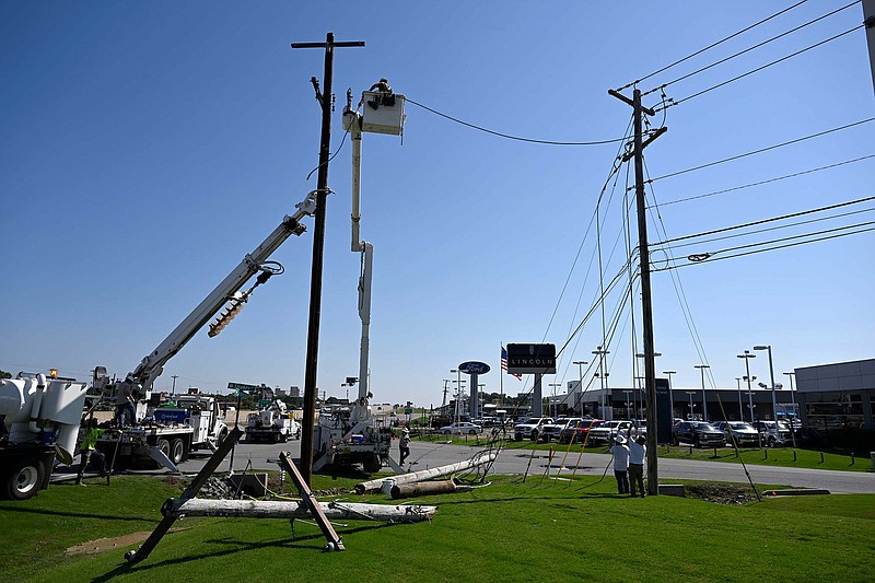 Crews work to repair downed power lines near Highway 67 in Sherwood on Monday, June 26, 2023. (Arkansas Democrat-Gazette/Stephen Swofford)