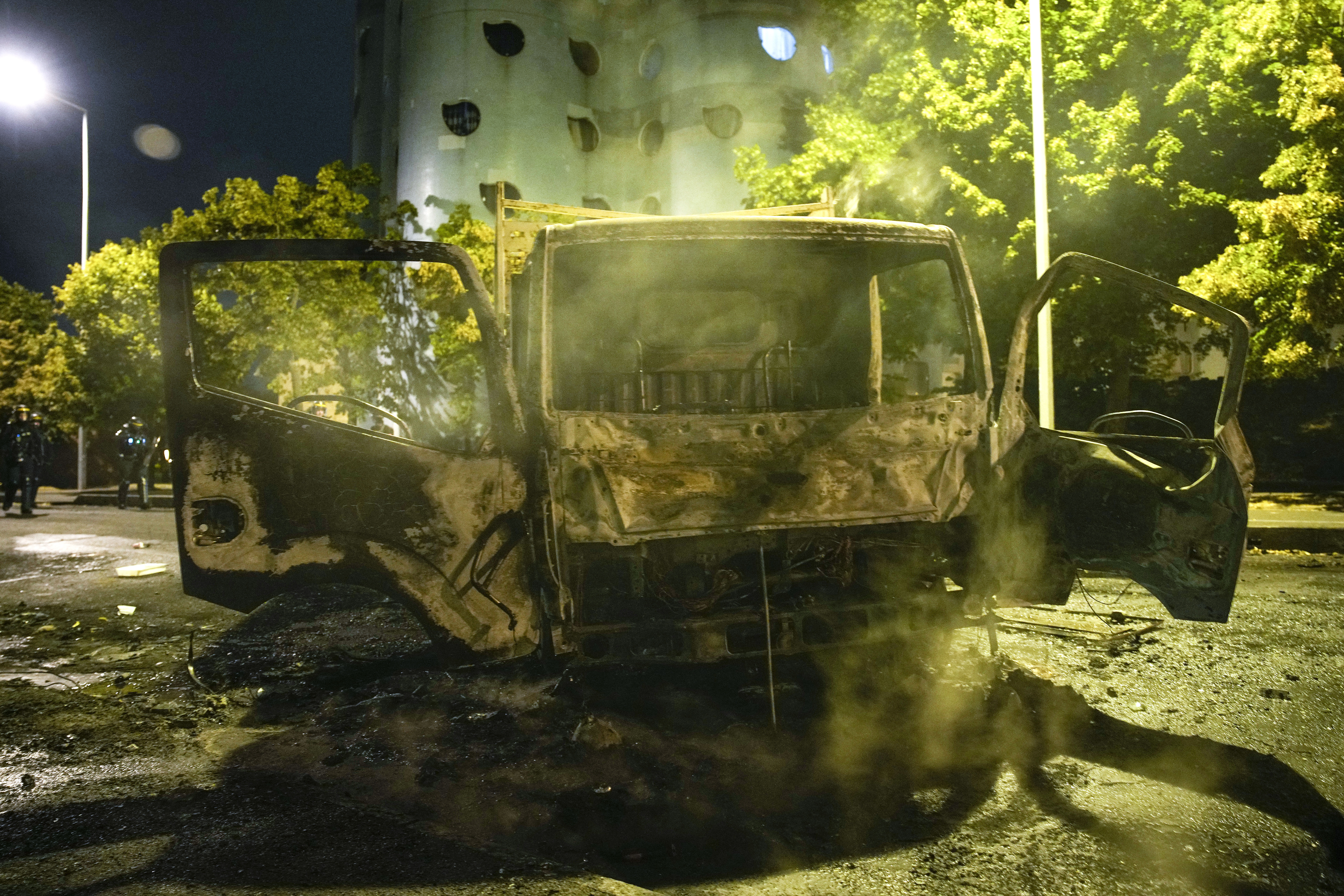 Charred cars are pictured in Nanterre, outside Paris, France, Saturday, July 1, 2023. French President Emmanuel Macron urged parents Friday to keep teenagers at home and proposed restrictions on social media to quell rioting spreading across France over the fatal police shooting of a 17-year-old driver. (AP Photo/Lewis Joly)