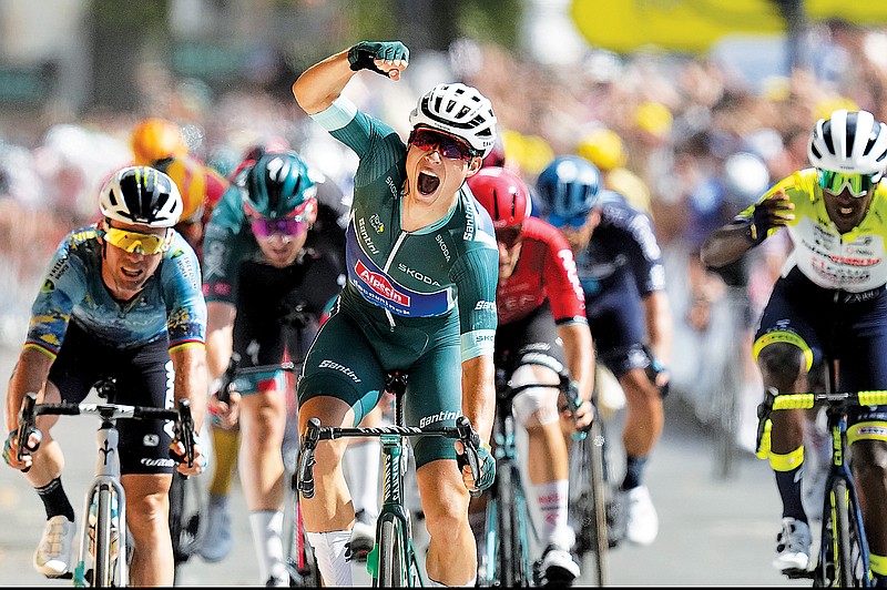 Jasper Philipsen celebrates as he crosses the finish line to win Friday’s seventh stage of the Tour de France spanning 105.5 miles with start in Mont-de-Marsan and finish in Bordeaux, France. (Associated Press)