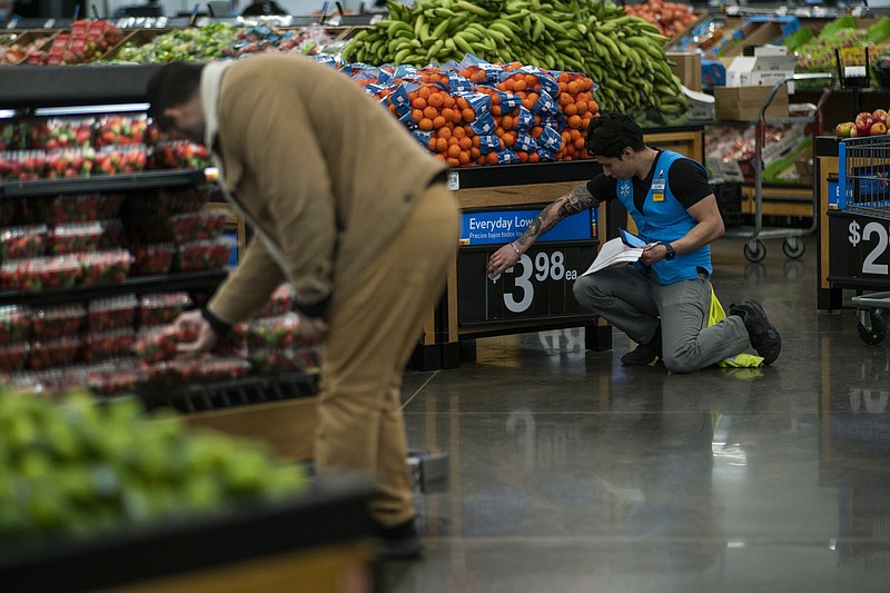 A Walmart employee works in the produce section of a Walmart Supercenter in North Bergen, N.J. in February.
(AP)