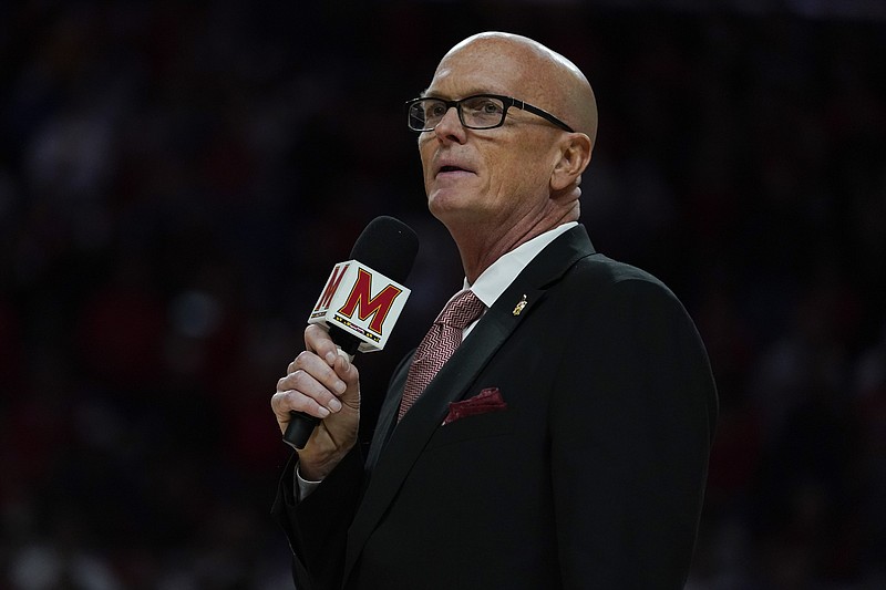 Broadcaster Scott Van Pelt presents the Maryland 2002 national championship team to be honored during a timeout in the first half of an NCAA college basketball game between Maryland and Ohio State, Sunday, Feb. 27, 2022, in College Park, Md. (AP Photo/Julio Cortez)