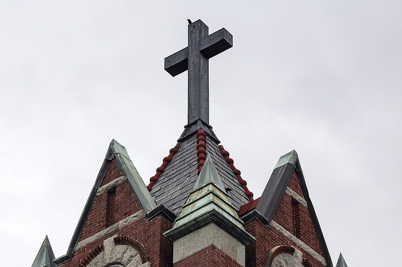 A bird is perched on top of the steeple at First United Methodist Church in Little Rock in this July 18, 2018 file photo. (Arkansas Democrat-Gazette file photo)