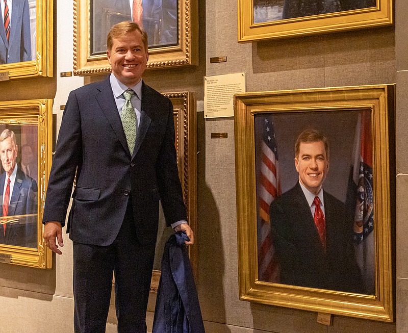 Matt Blunt, Missouri’s 54th governor, stands with his portrait after it was unveiled Friday afternoon. Blunt served as governor from 2005-09,and was the second-youngest person to ever be elected governor.