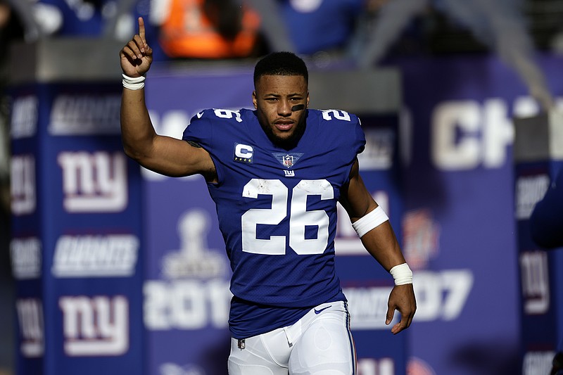 FILE - New York Giants running back Saquon Barkley is introduced before an NFL football game against the Indianapolis Colts, Jan. 1, 2023, in East Rutherford, N.J. Barkley and the Giants settled on a contract for the star running back just in time for training camp, signing a one-year contract worth up to $11 million, a source close to the negotiations told The Associated Press on Tuesday, July 25, 2023. (AP Photo/Adam Hunger, File)