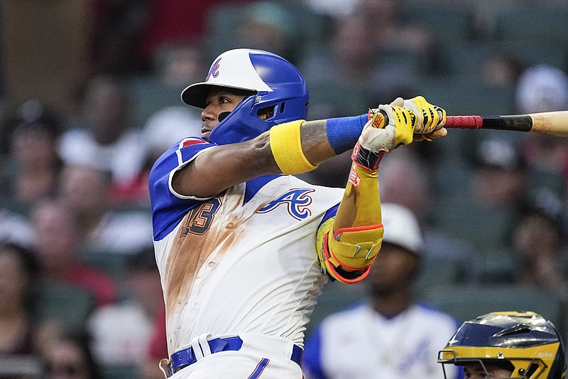 Atlanta Braves' Ronald Acuna Jr. watches his two-run home run against the Milwaukee Brewers during the fourth inning of a baseball game Saturday, July 29, 2023, in Atlanta. (AP Photo/John Bazemore)