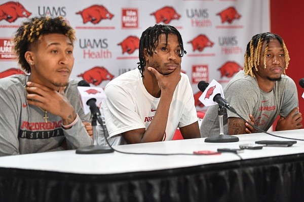 Arkansas player Tramon Mark (center) a transfer from Houston, speaks Tuesday, Aug. 1, 2023, alongside Jeremiah Davenport (left), a transfer from Cincinnati, and El Ellis, a transfer from Louisville, during a press conference in Bud Walton Arena in Fayetteville. Visit nwaonline.com/photo for the photo gallery.