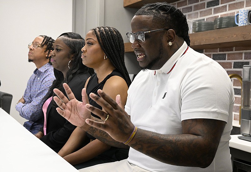 Demetria (center) and Myron Heard, with Jason (far left) and Dia Nicholson, speak at their lawyer’s office in Little Rock on Thursday. Demetria and Myron Heard were held at gunpoint with their son, Kaileb Henderson, and their nephew, Jayden Nicholson, during a traffic stop in Frisco, Texas, after the officer mistakenly entered “AZ” rather than “AR” while running their license plate.
(Arkansas Democrat-Gazette/Stephen Swofford)