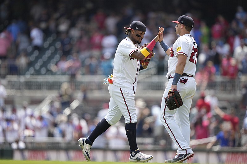 Atlanta Braves' Ronald Acuna Jr., left, celebrates with Austin Riley, right, after a win against the Los Angeles Angels, Wednesday, Aug. 2, 2023, in Atlanta. (AP Photo/Brynn Anderson)
