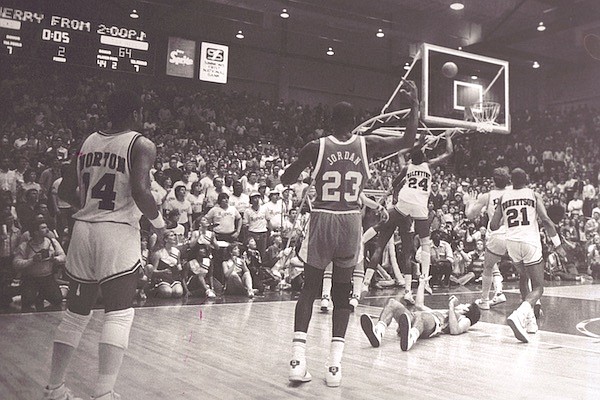 Michael Jordan of North Carolina (23) watches as Charles Balentine of Arkansas (24) hits a game-winning shot to give the Razorbacks a 65-64 victory over the top-ranked Tar Heels on Sunday, Feb. 12, 1984, in Pine Bluff. (Photo courtesy Arkansas Athletics)