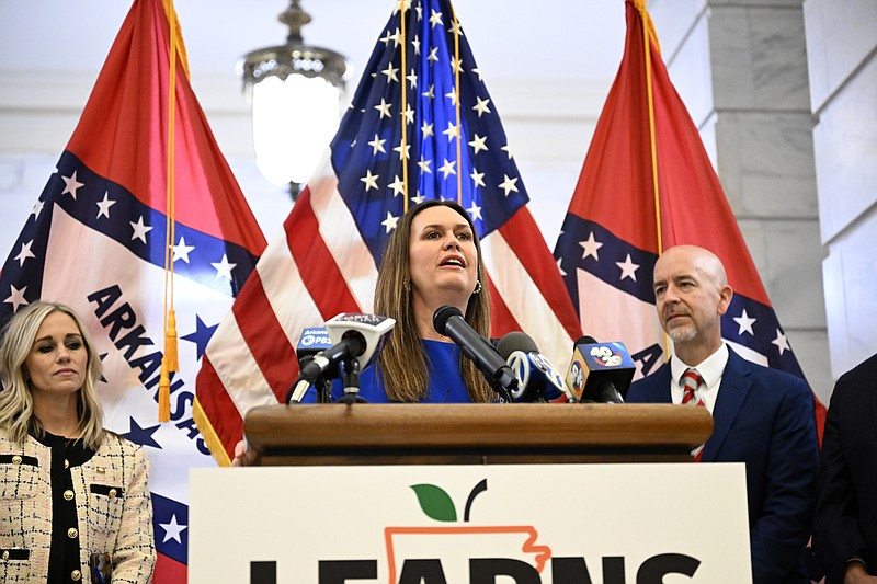 Governor Sarah Huckabee Sanders, center, addresses the media with Senator Breanne Davis, R-Russellville, left, and Secretary of Education Jacob Oliva during a signing ceremony for the LEARNS act on the second floor rotunda of the State Capitol on Wednesday, March 8, 2023...(Arkansas Democrat-Gazette/Stephen Swofford)