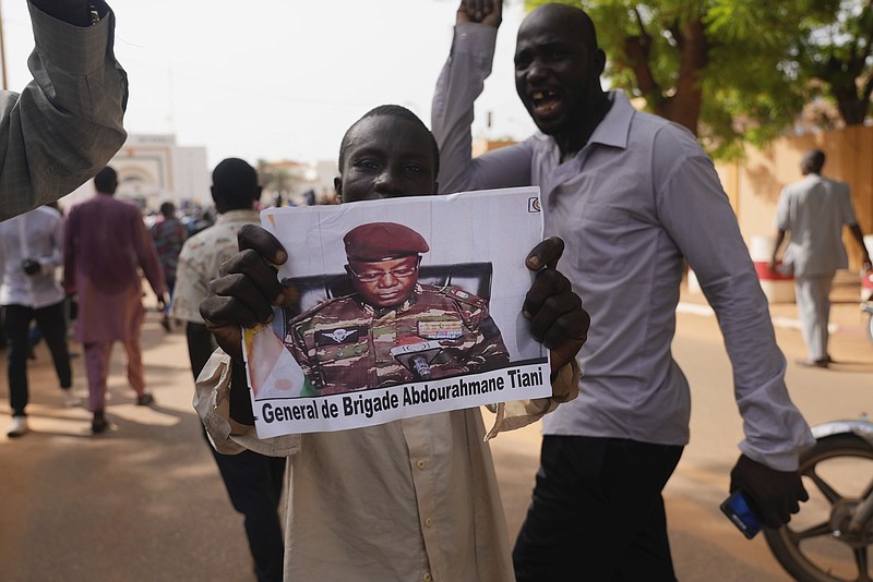 Nigeriens participate in a march called by supporters of coup leader Gen. Abdourahmane Tchiani, pictured, in Niamey, Niger, Sunday, July 30, 2023. Days after after mutinous soldiers ousted Niger's democratically elected president, uncertainty is mounting about the country's future and some are calling out the junta's reasons for seizing control. (AP Photo/Sam Mednick)