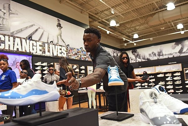 Arkansas basketball guard Davonte "Devo" Davis assists 23 players from Jacksonville High School’s basketball teams with shopping for the upcoming school year Wednesday, Aug. 9, 2023, at DICK’S Sporting Goods in North Little Rock.
